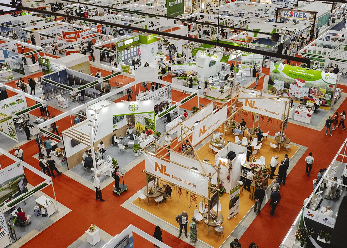 A dynamic overview of HortEx, where international exhibitors showcase horticultural innovation across bustling national pavilions.